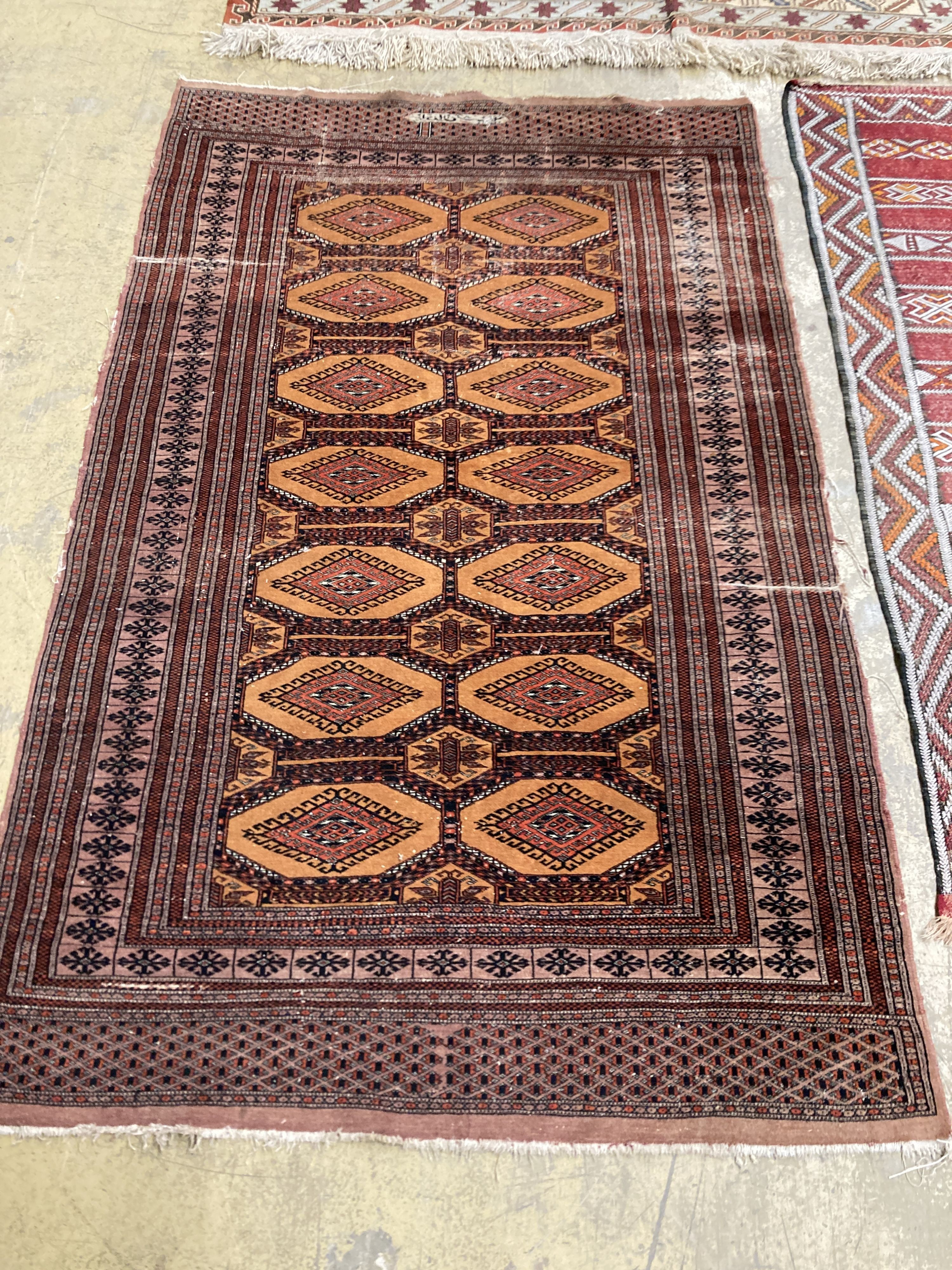 A Bokhara orange ground rug 198 x 125 cms, a smaller Anatolian flat weave rug and Bokhara prayer mat.